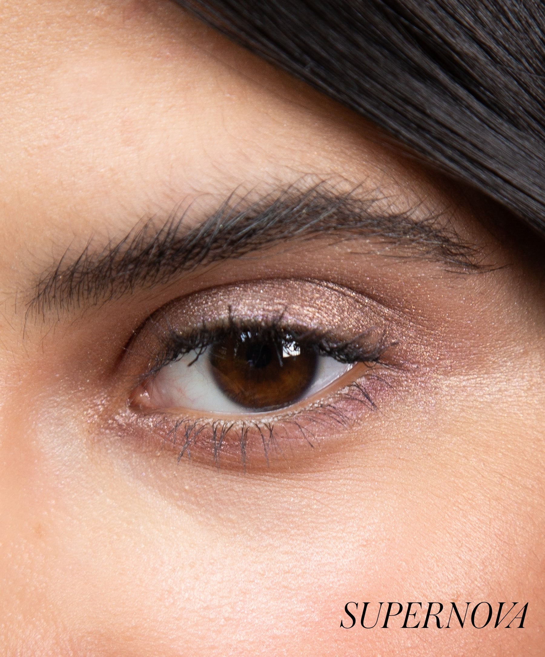 Close-up of model wearing RMS Eyelights Cream Eyeshadow shade Supernova