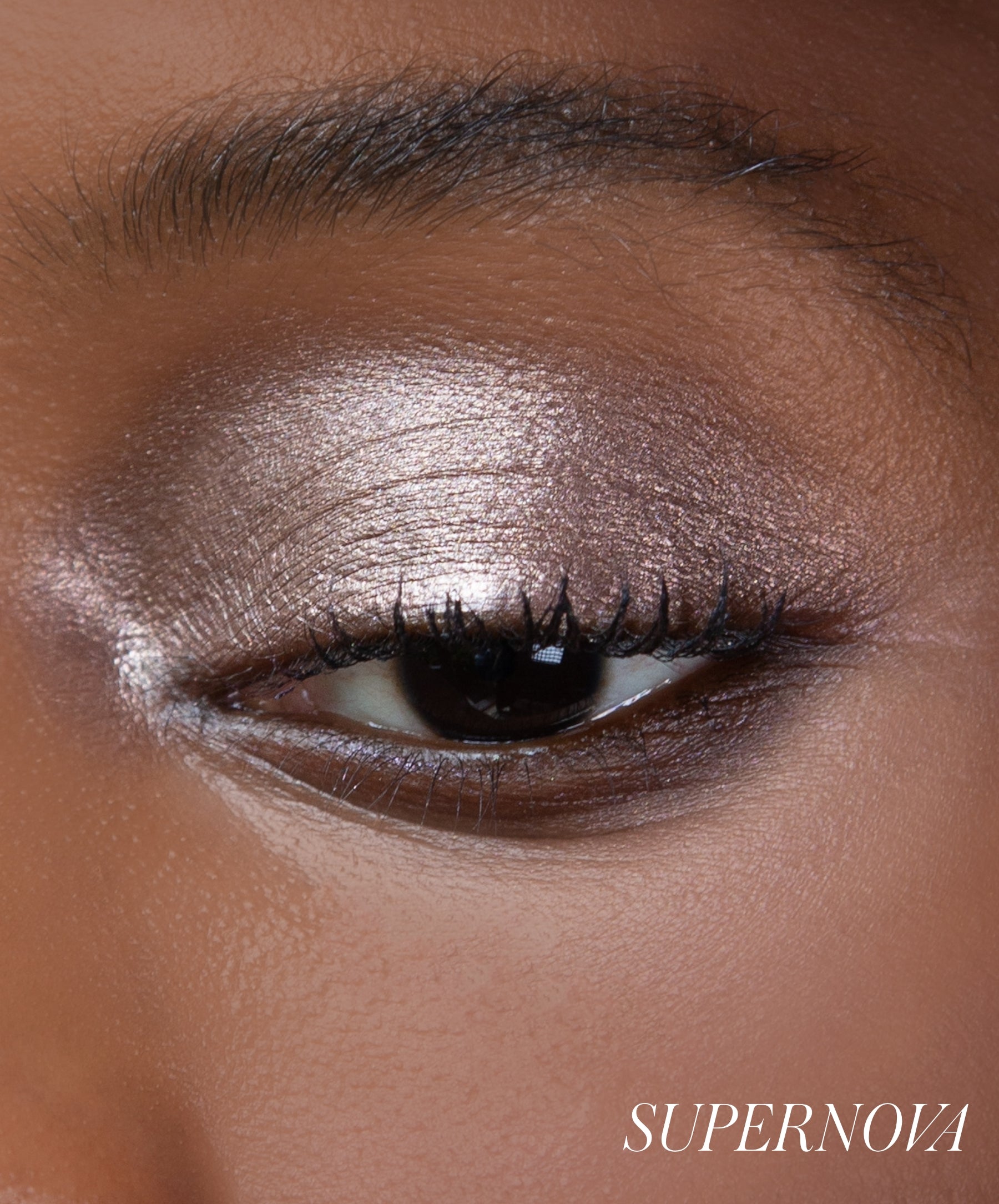 Close-up of model wearing RMS Eyelights Cream Eyeshadow shade Supernova