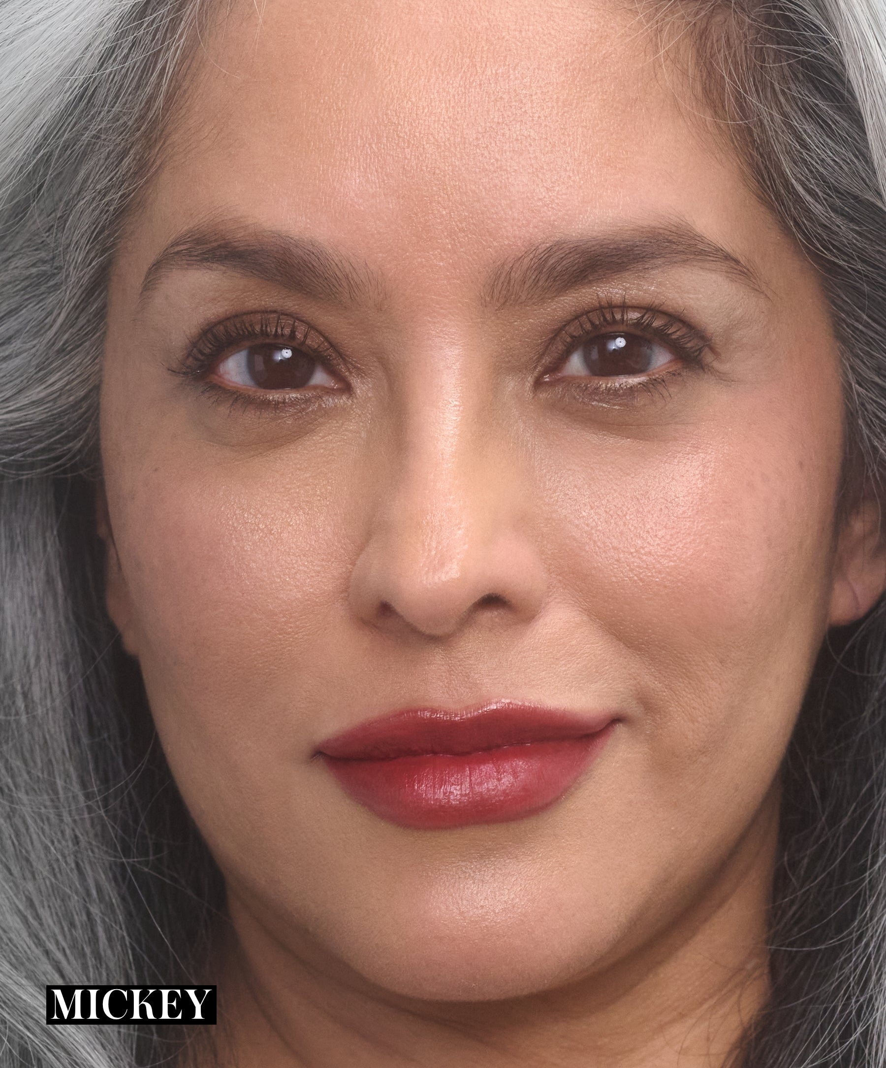 Model wearing RMS Legendary Serum Lipstick in shade Mickey