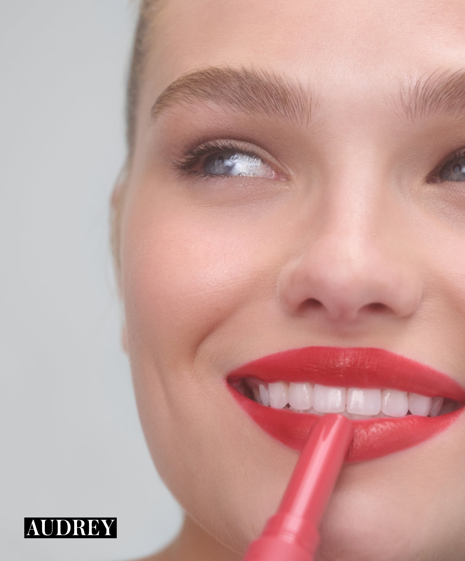 Model applying RMS Legendary Serum Lipstick in shade Audrey