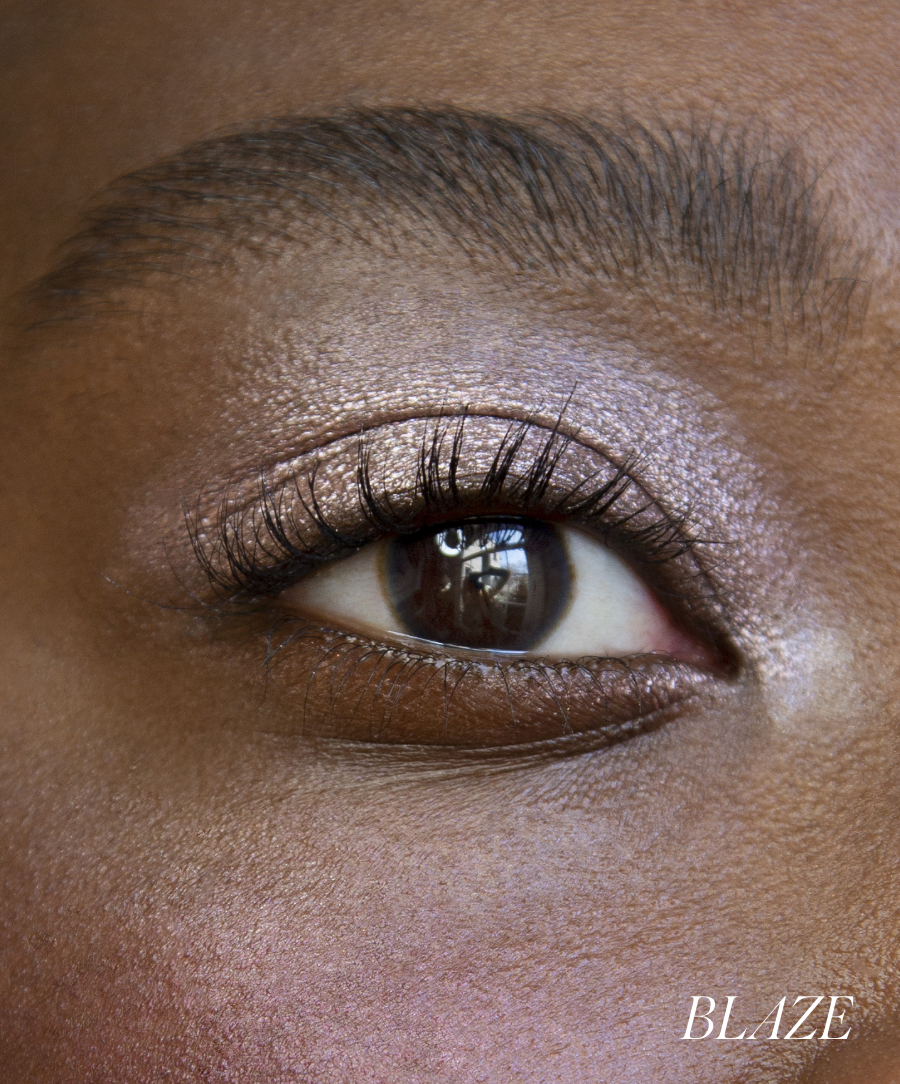 Close-up of model wearing RMS Eyelights Cream Eyeshadow in shade Blaze