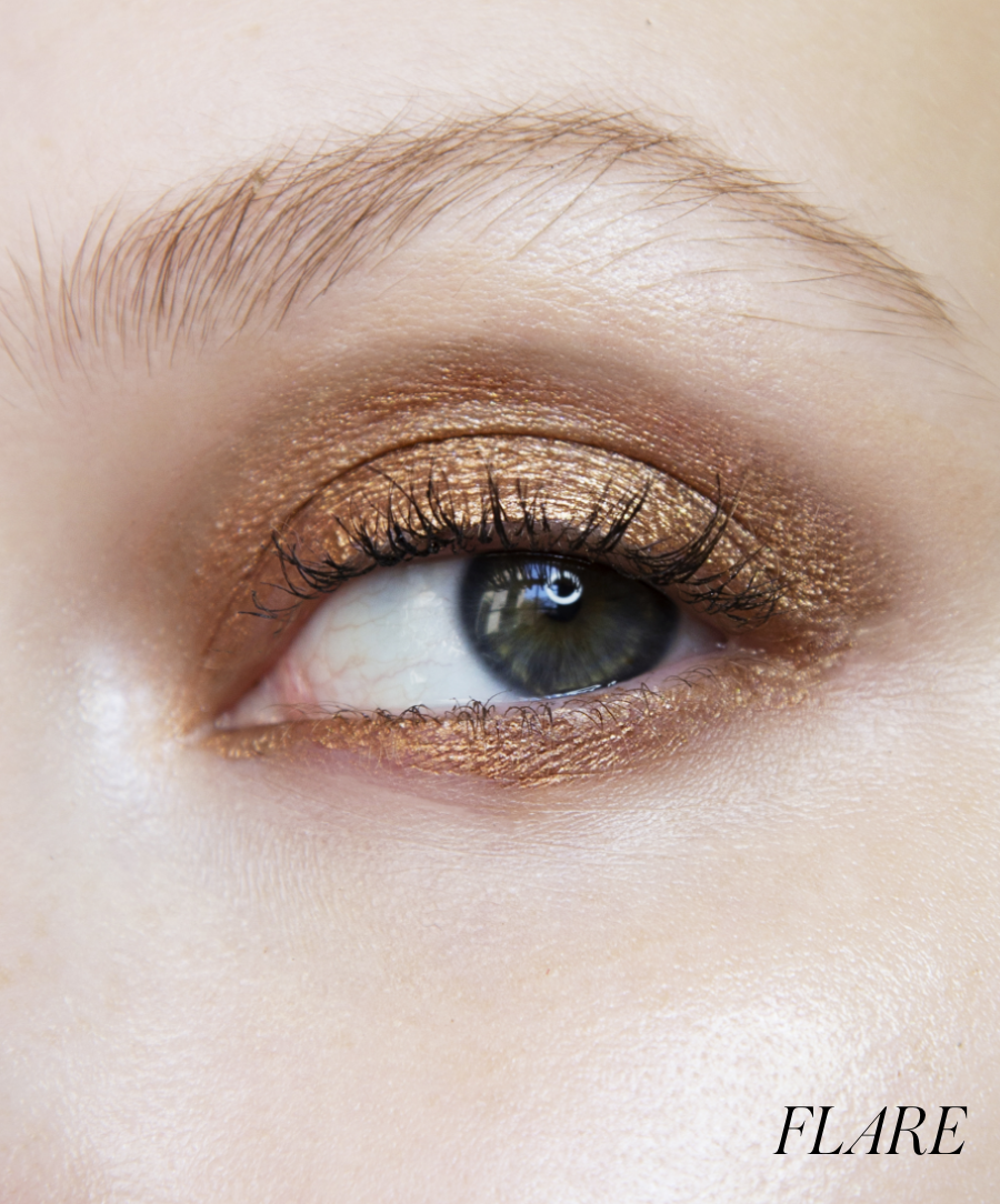 Close-up of model wearing RMS Eyelights Cream Eyeshadow in shade Flare