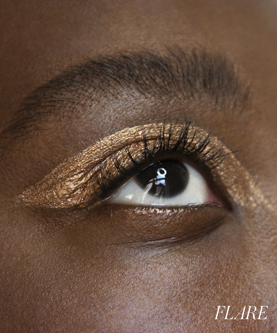 Close-up of model wearing RMS Eyelights Cream Eyeshadow in shade Flare