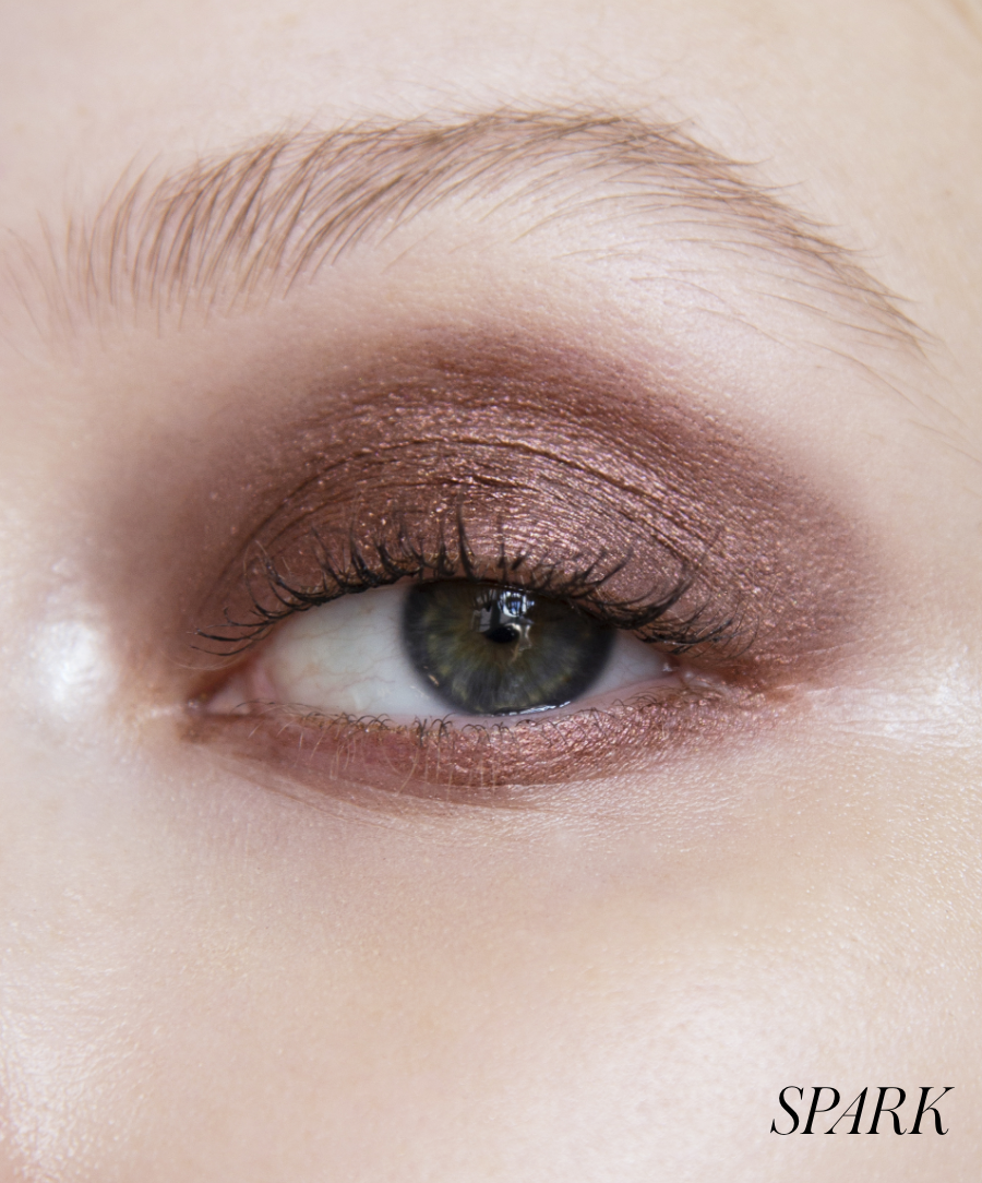 Close-up of model wearing RMS Eyelights Cream Eyeshadow in shade Spark