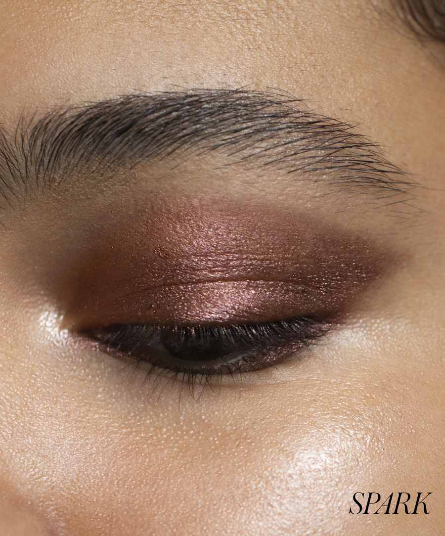 Close-up of model wearing RMS Eyelights Cream Eyeshadow in shade Spark