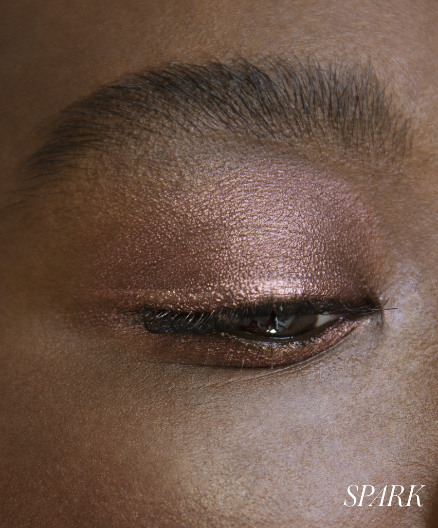 Close-up of model wearing RMS Eyelights Cream Eyeshadow in shade Spark