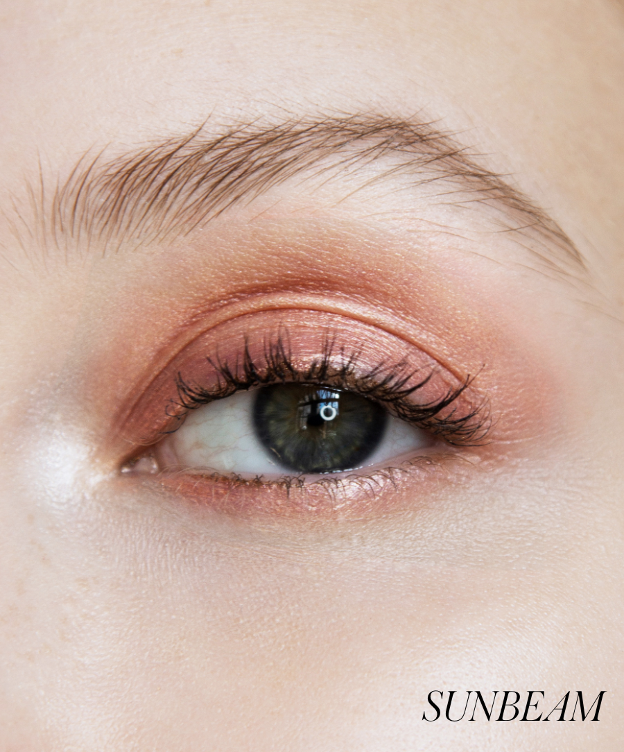 Close-up of model wearing RMS Eyelights Cream Eyeshadow in shade Sunbeam