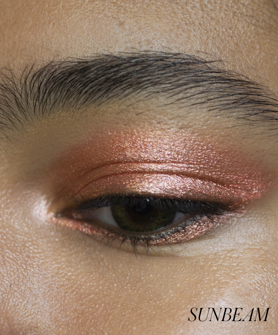 Close-up of model wearing RMS Eyelights Cream Eyeshadow in shade Sunbeam