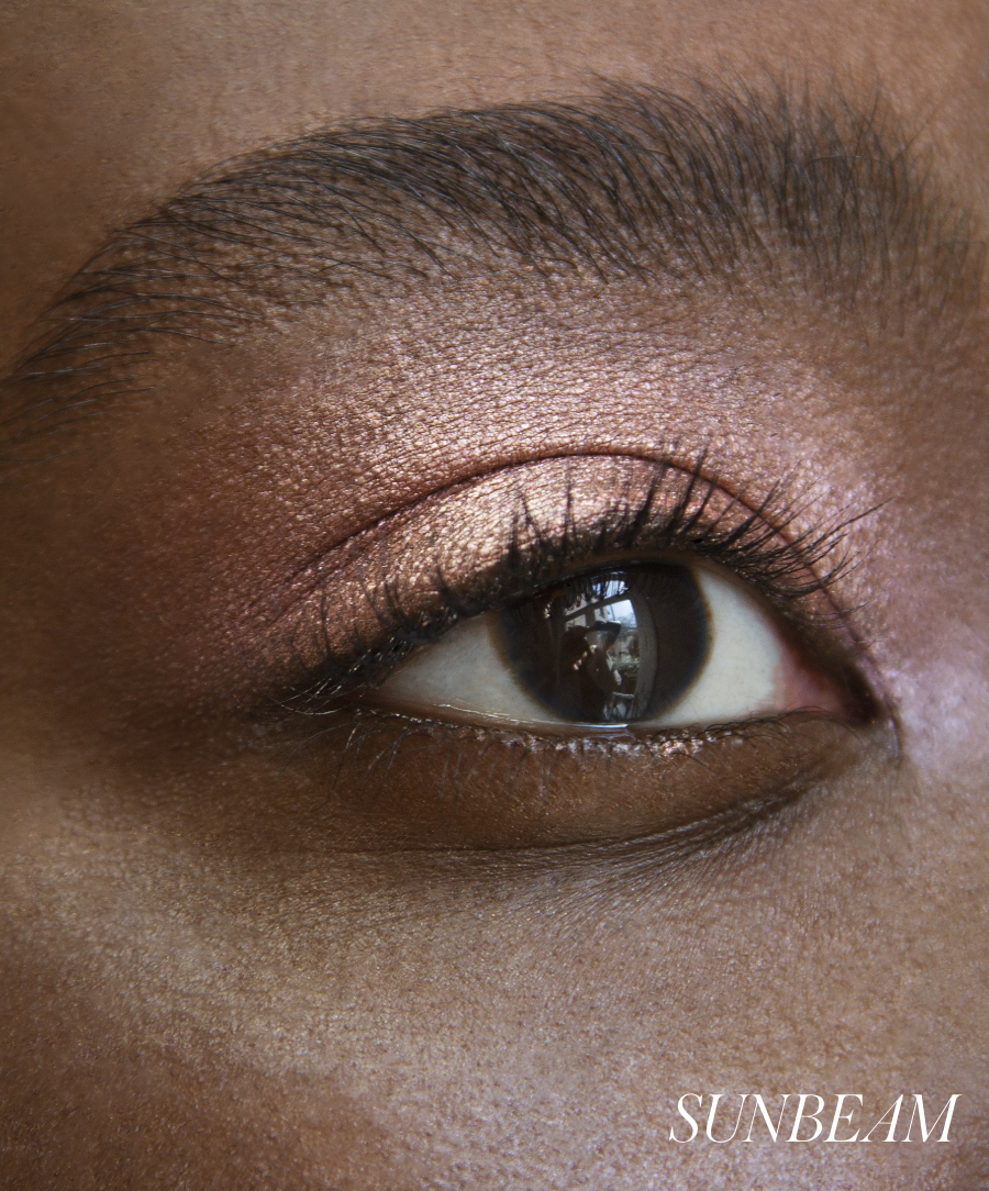 Close-up of model wearing RMS Eyelights Cream Eyeshadow in shade Sunbeam