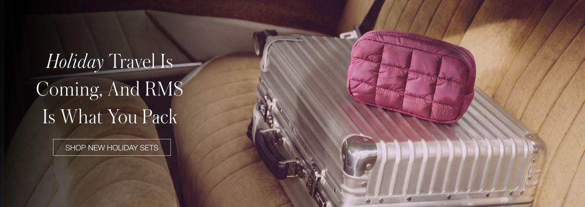 Holiday travel banner with a pink quilted pouch on a silver suitcase beside a chair and overlaid text about RMS holiday sets