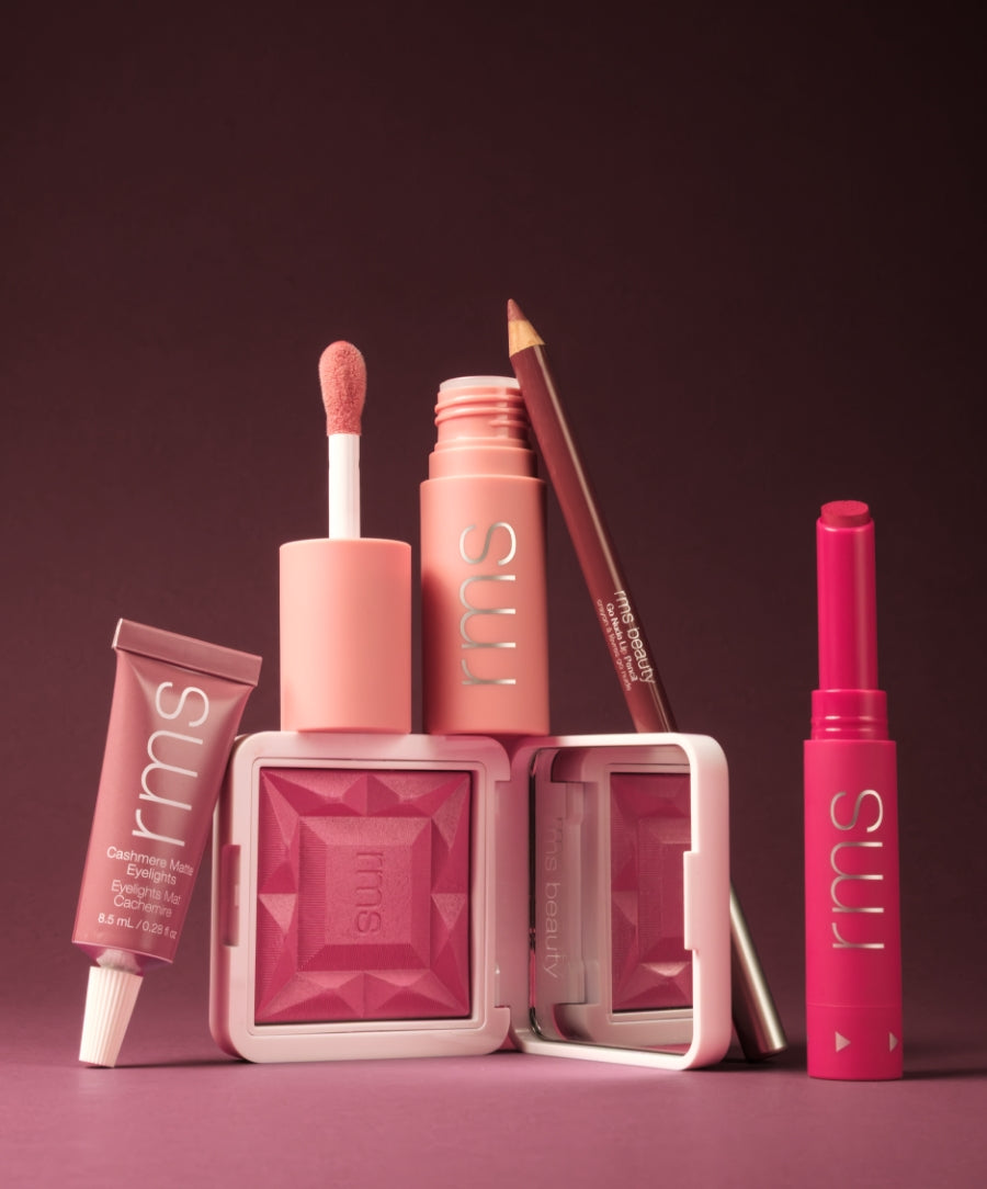 Collection of RMS Beauty makeup products in shades of pink and raspberry, featuring a lip gloss, eyeshadow, lip liner, and cream blush with clean ingredients in sustainable packaging, Color Capsule: The Raspberry Wine Sorbet Edit.