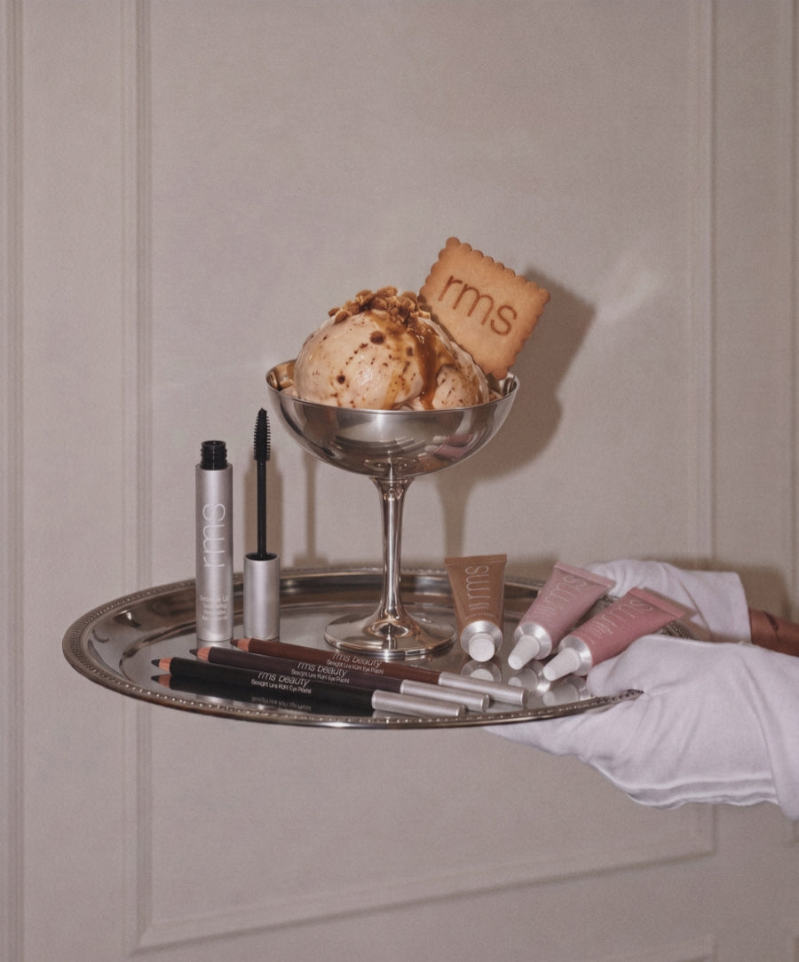 The Eye Wardrobe: Creaseproof + Smudge-Proof Eye Makeup with eye pencils mascara and cream products arranged on a silver tray