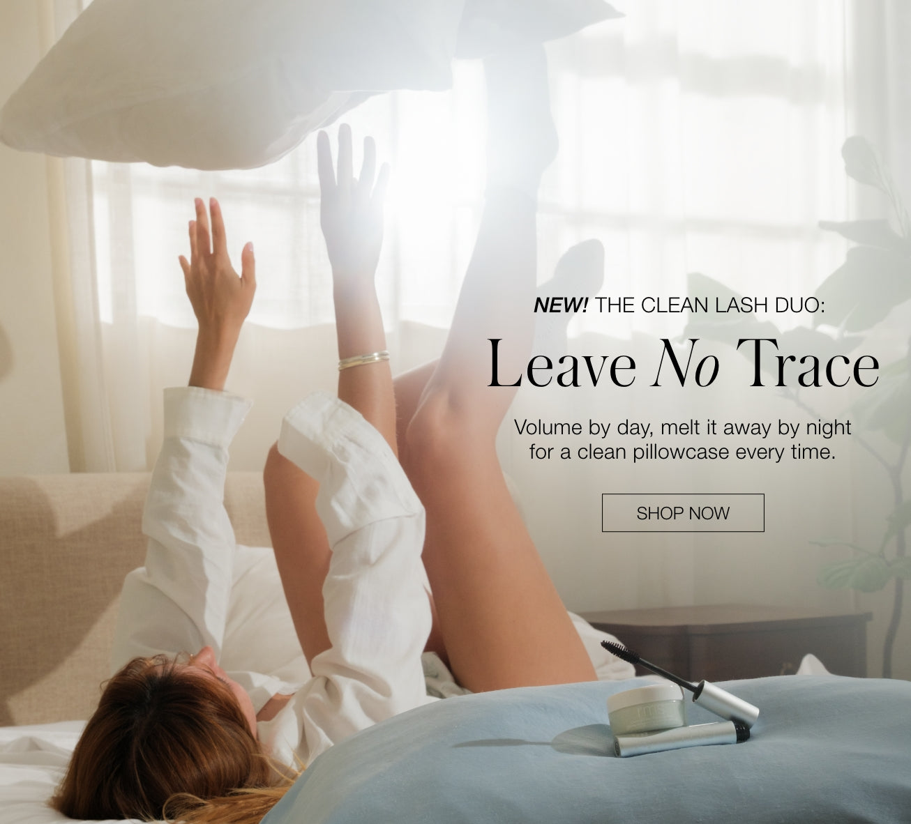 Woman reclining on a bed with raised arms and legs beside a mascara tube and brush with text reading Leave No Trace clean lash duo and Shop Now button