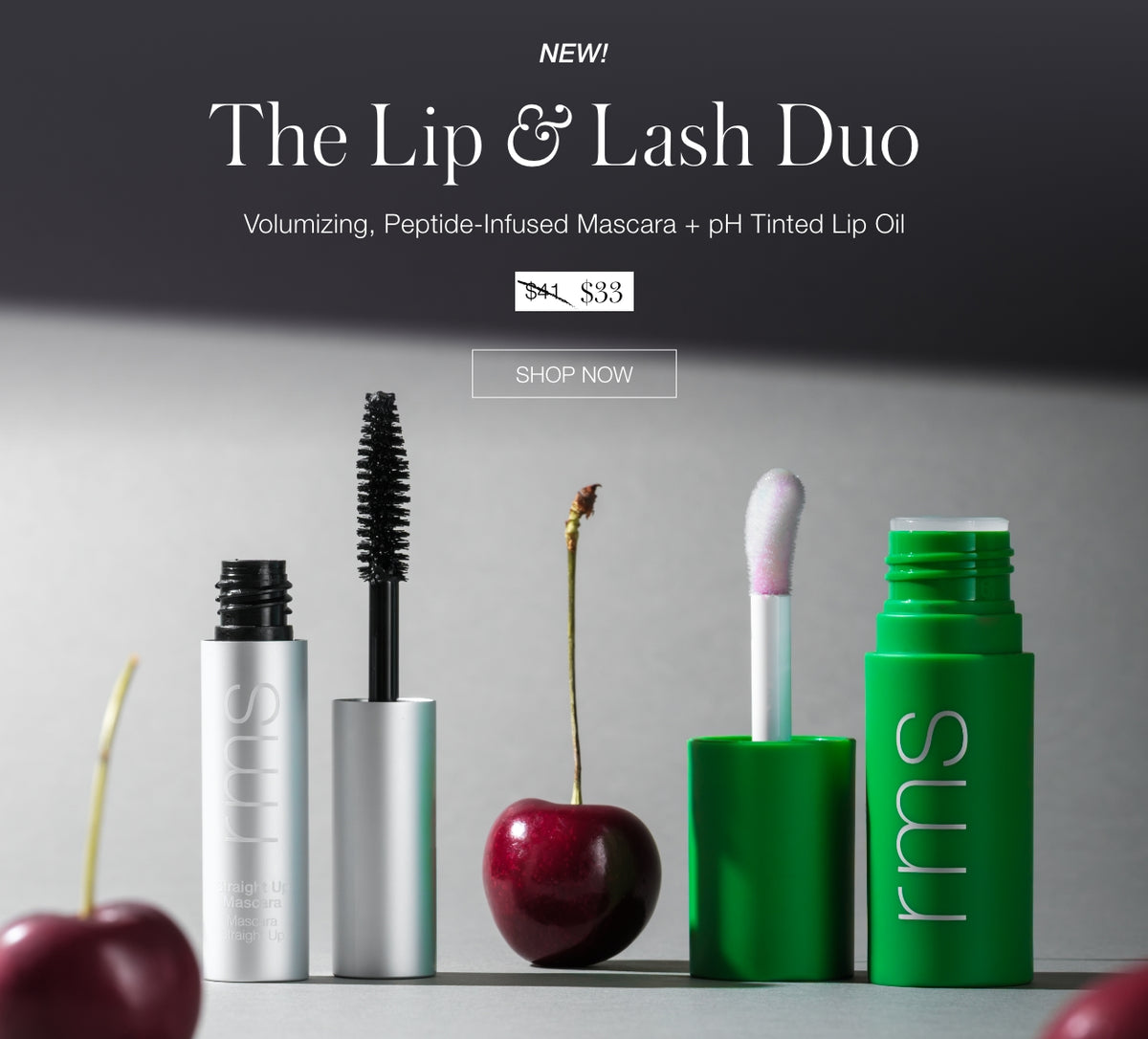 Beauty banner displaying The Lip and Lash Duo with mascara and tinted lip oil tubes beside cherries and a cotton swab plus a Shop Now button